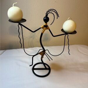 “Vintage African-inspired metal figurine candle holder”
